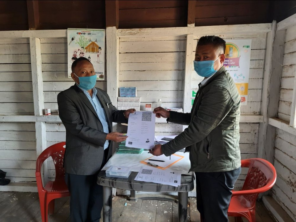 CMO, Wokha, Dr CW Tungoe receives his final certificate for COVID-19 vaccine after taking the second dose at Urban Primary Health Centre Wokha on February 18. (Photo Courtesy: CMO office Wokha)